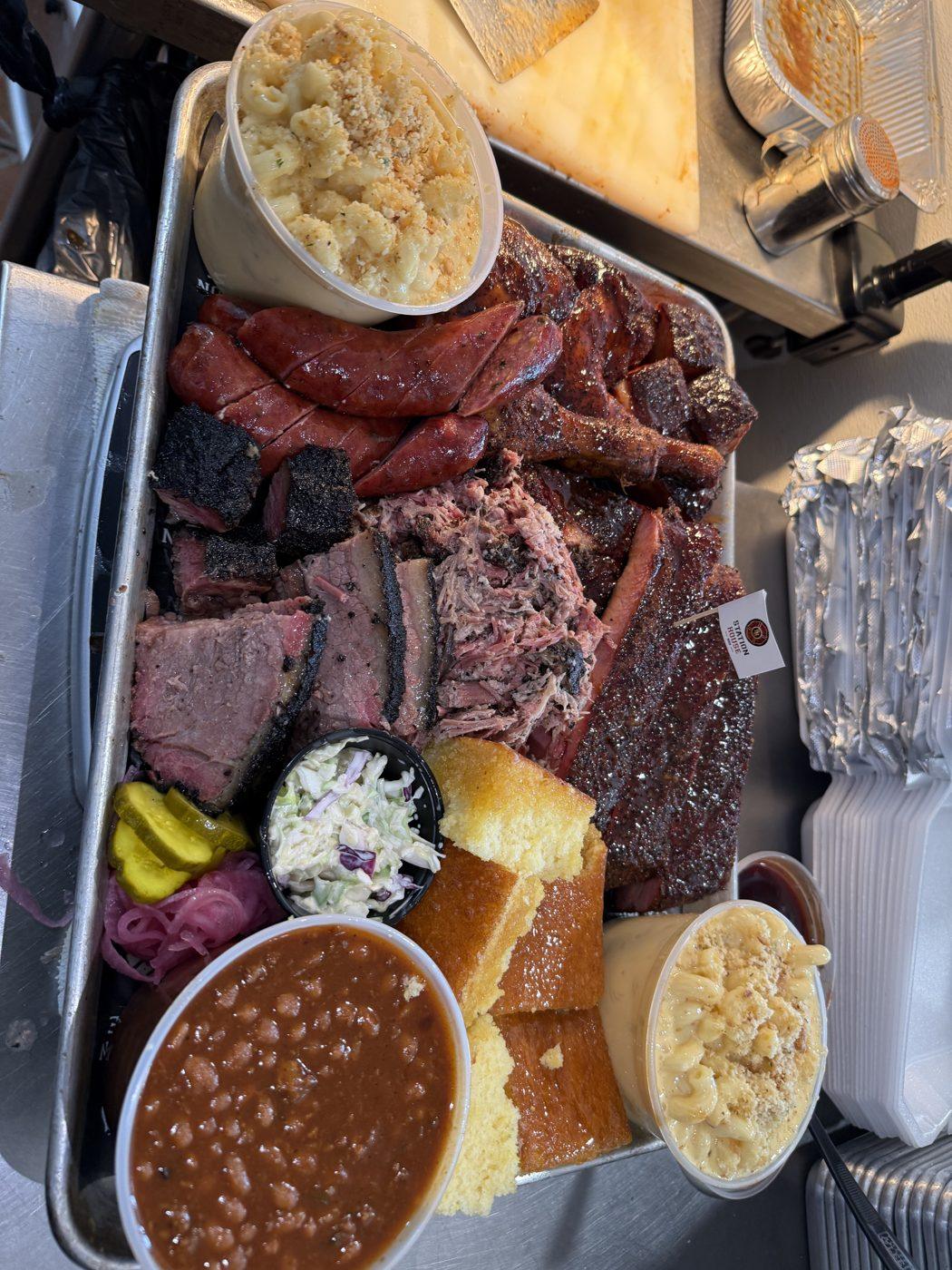 Station House BBQ party spread with smoked meats and homemade sides